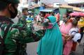 Anggota TNI Periksa Suhu Tubuh Pengunjung Pasar Serdang Kemayoran